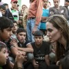 This June 18, 2013 photo released by the United Nations High Commissioner for Refugees (UNHCR) shows special envoy Angelina Jolie, right, speaking with Syrian refugees in a Jordanian military camp based near the Syria-Jordan border. The Syrian civil war contributed to pushing the numbers of refugees and those displaced by conflict within their own nation to an 18-year high of 45.2 million worldwide by the end of 2012, the U.N. refugee agency said Wednesday, June 19. Most of the refugees in the world have fled from five war-affected countries: Afghanistan, Somalia, Iraq, Syria and Sudan. (AP Photo/United Nations High Commissioner for Refugees , O. Laban-Matte) UN-Worldwide Refugees Jolie